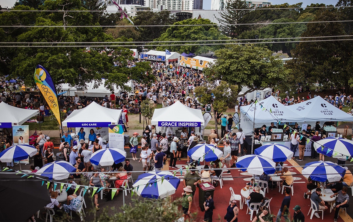 a festival with blue striped umbrellas and pop up tents